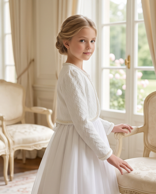 Girl wearing white pearl trim communion jacket back view showing textured knit fabric and pearl collar detail in church