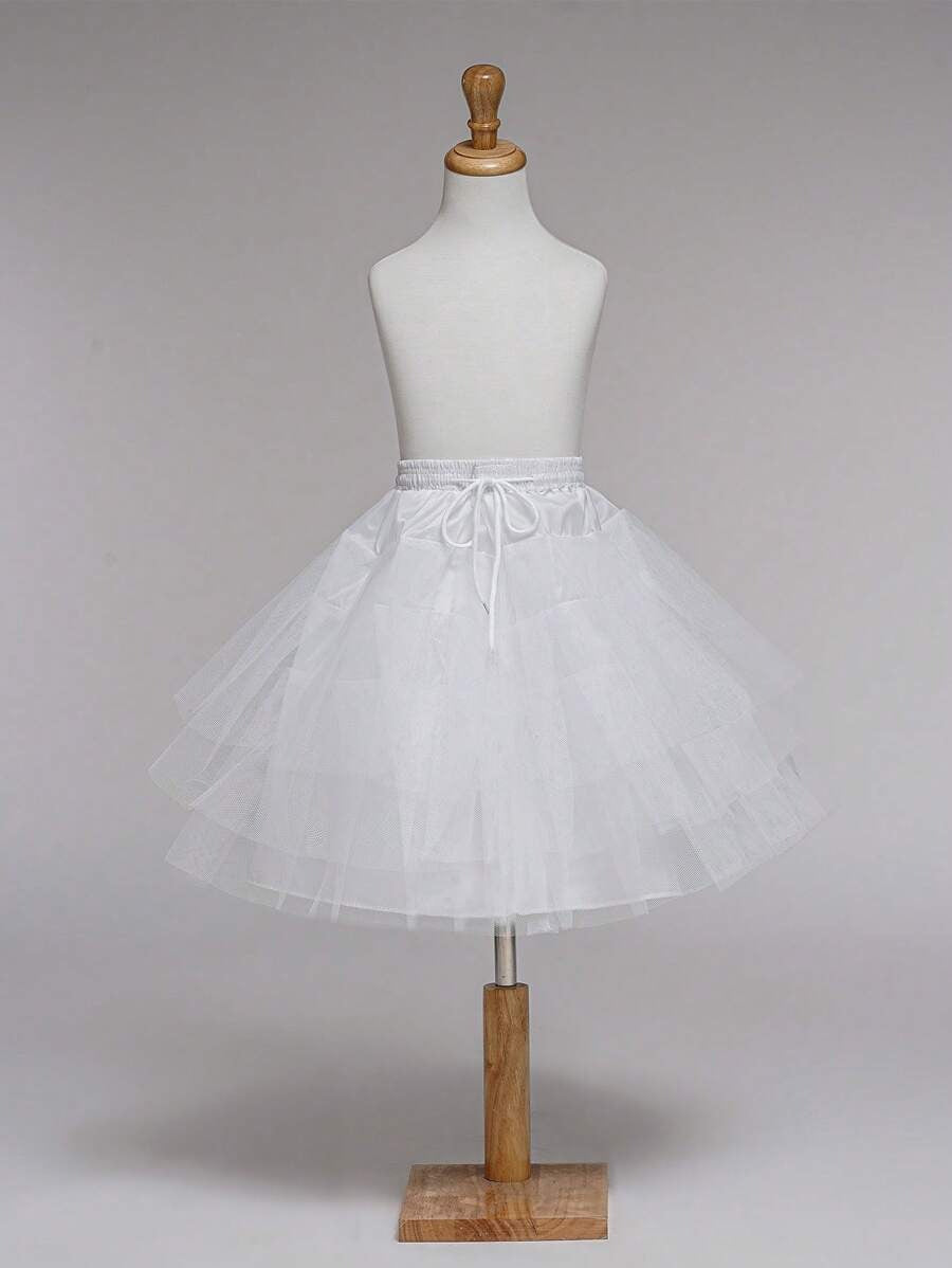 White petticoat on a mannequin against a plain background