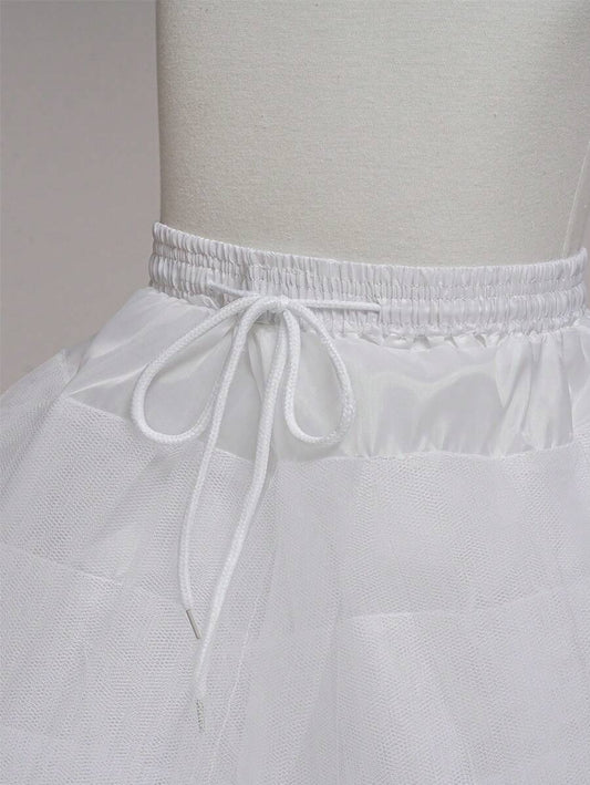 White petticoat on a mannequin against a plain background