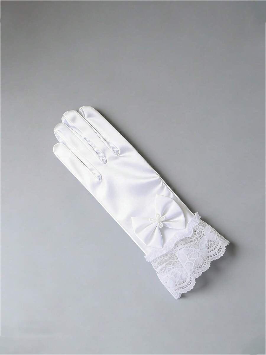 White glove with lace detailing on a gray background