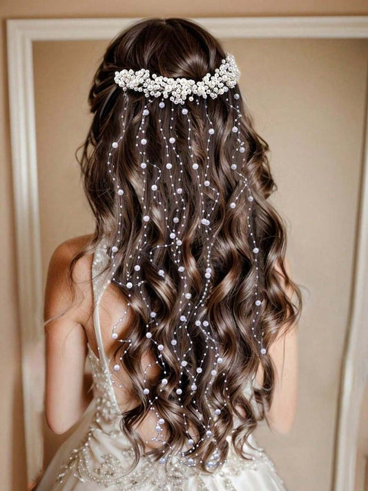 Woman with wavy hair wearing a pearl headband and hair extensions.