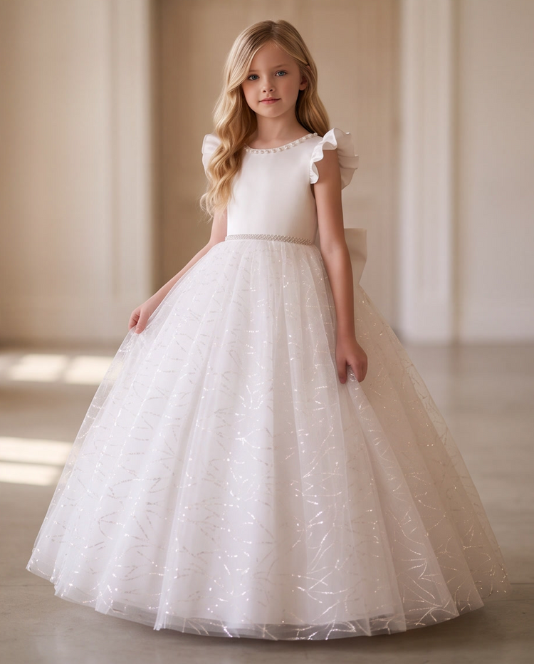 Close-up back view of pearl-trimmed V-back and oversized satin bow on white glitter ball gown