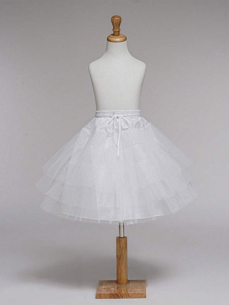 White petticoat on a mannequin against a plain background
