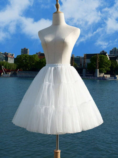 Girls white four-layer tulle petticoat on mannequin outdoors, full voluminous silhouette