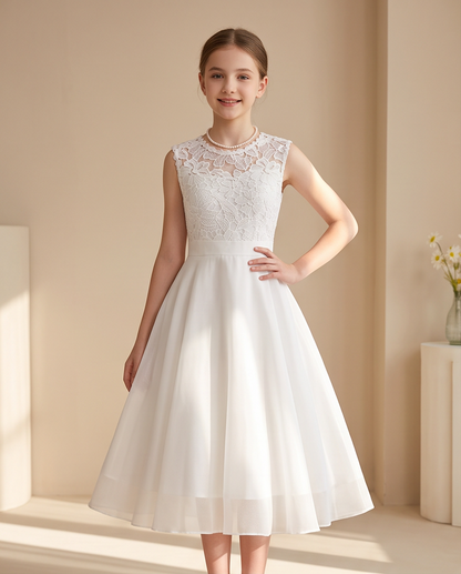 Girl wearing a white chiffon communion dress
