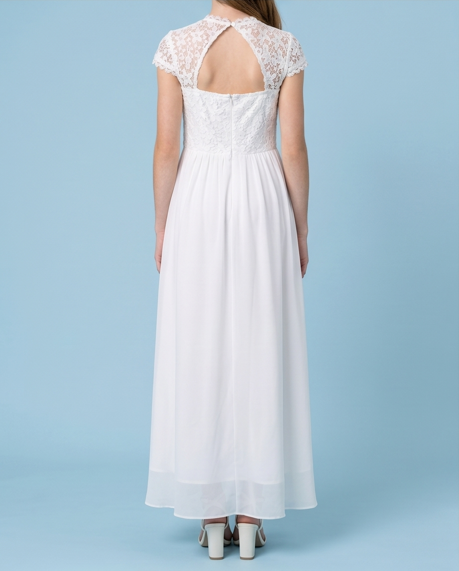 A woman viewed from the back wearing a white maxi dress with a lace open-back neckline, cap sleeves, and a flowing skirt, standing against a light blue studio background.