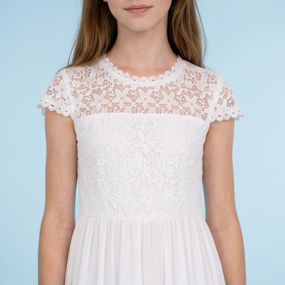A girl wearing a white lace dress with short cap sleeves and a pleated skirt, shown from the nose down against a light blue background.