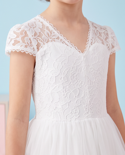 White lace and tulle dress with short cap sleeves, a V-neckline, and a flared skirt, shown on a model against a light blue background.