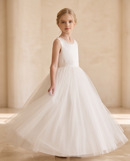 Girl wearing a pearl satin communion dress