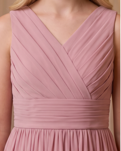 Close-up of a sleeveless dusty pink dress with a V-neckline, diagonal pleated bodice, and a gathered waistband.