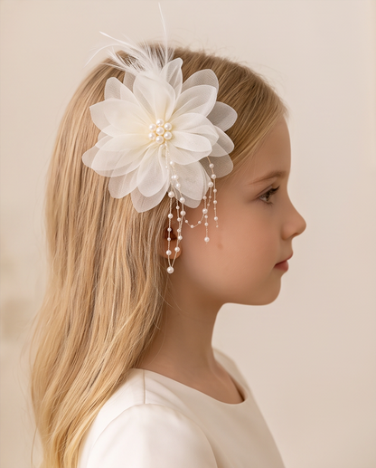 Girl wearing white flower fascinator with feathers and pearl chain tassel hair clip, side profile view
