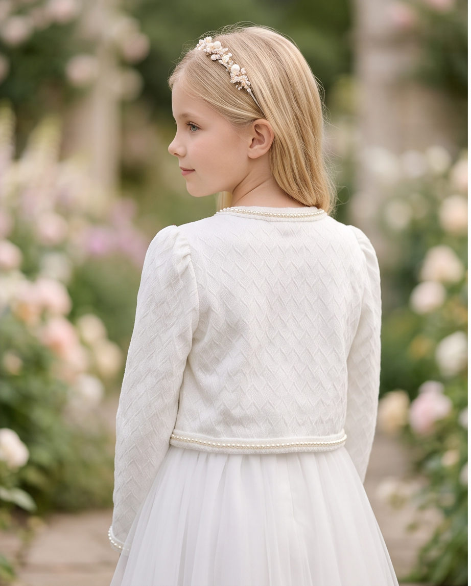 Close-up of pearl trim detail along neckline and front opening of white communion jacket