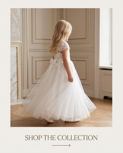 Girl in white lace communion dress holding bouquet full length front view