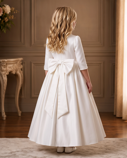 Girl wearing a white satin communion dress