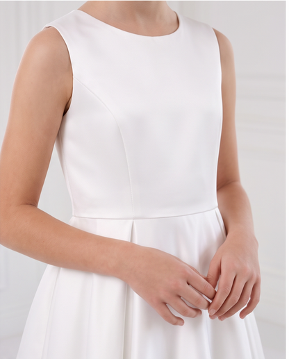 A sleeveless white dress with a fitted bodice and flared skirt, shown on a model against a soft white background.