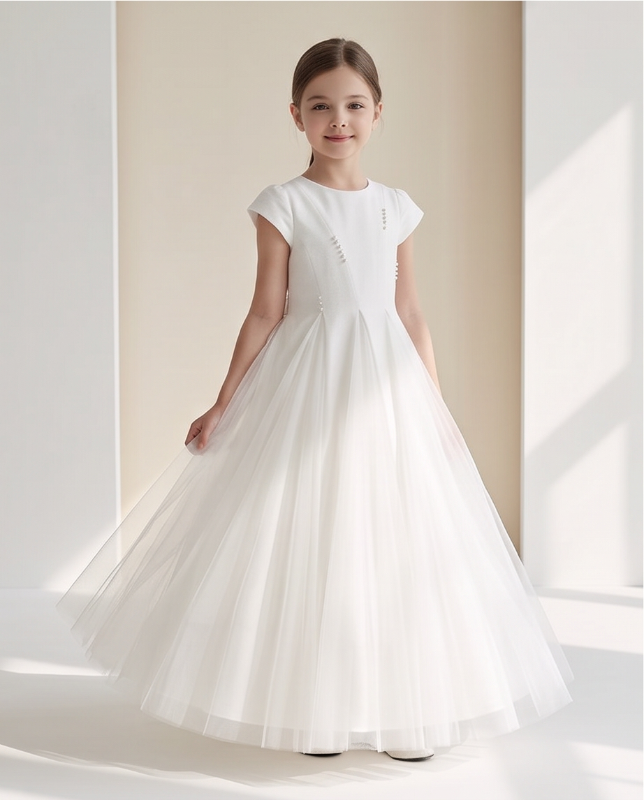 Girl wearing white pearl detail communion dress with tulle skirt front view