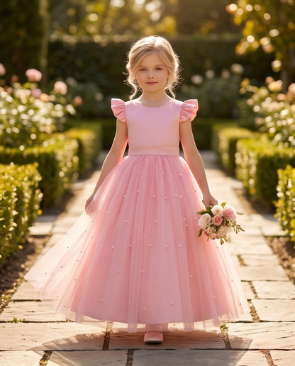 Girl wearing pink pearl tulle flower girl dress full length front view indoors