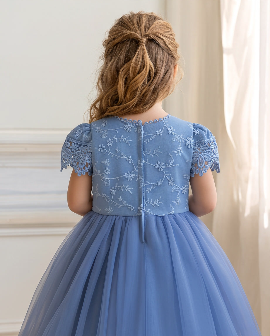 Girls dusty blue lace cap sleeve dress full length standing