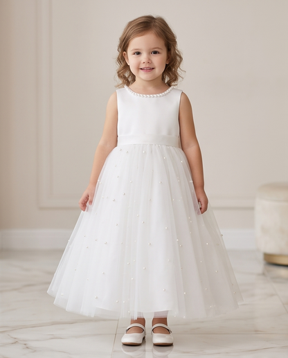 Girl wearing white pearl tulle dress full length back view showing bow detail