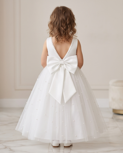 Close-up of pearl scattered tulle skirt on white communion dress