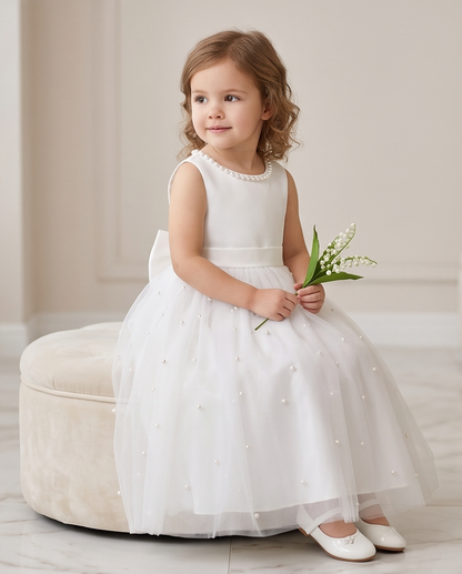 Girl wearing white pearl tulle dress elegant front pose indoors