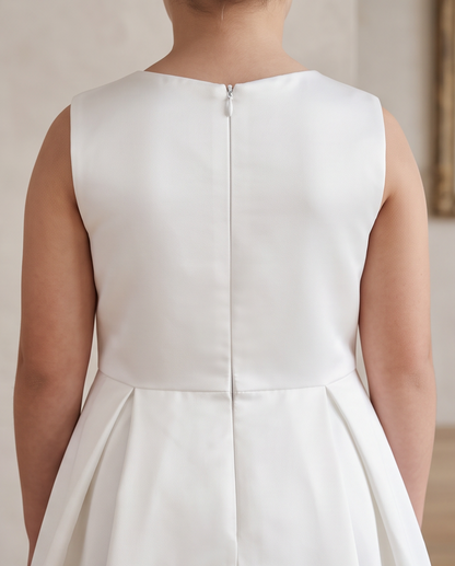 girl wearing white satin and lace communion dress