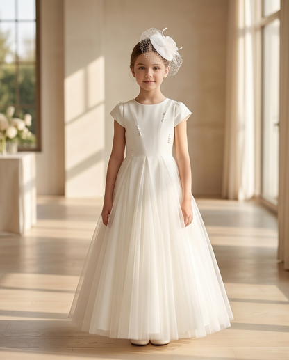 girl wearing white tulle communion dress