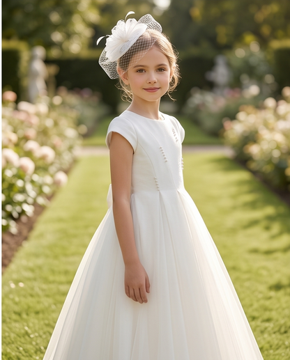 girl wearing white tulle communion dress