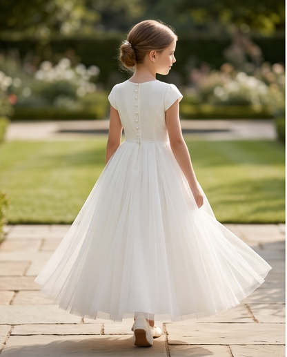 girl wearing white tulle communion dress