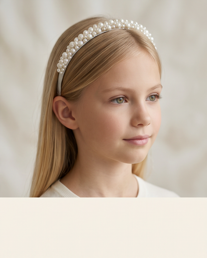 Pearl and crystal communion tiara styled on a girl in a blue dress
