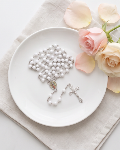 Close-up of Our Lady of Guadalupe rosary medal and silver-tone crucifix