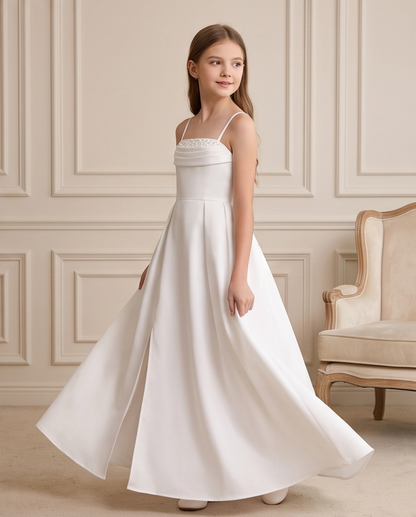 Detail view of white girls communion dress skirt and straps