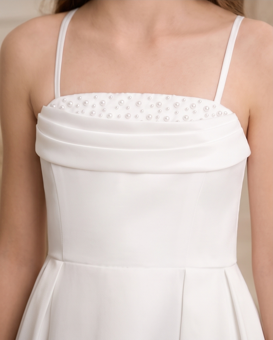 Back view of white girls communion dress with cross-back straps