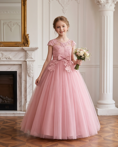Close-up of floral lace appliqué and satin bow on pink flower girl dress
