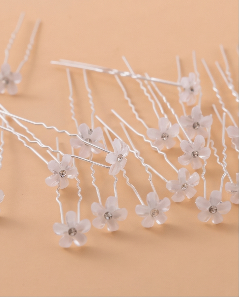 White floral pins in an updo