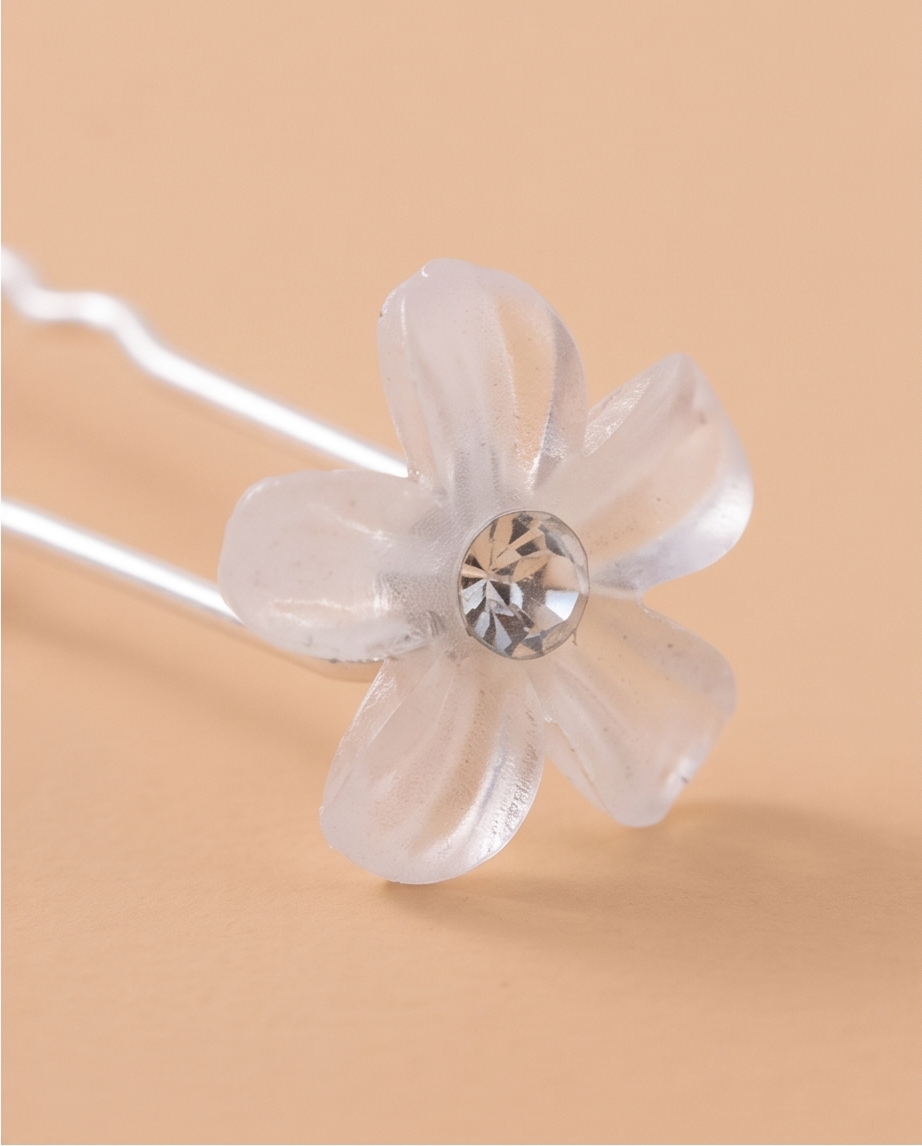 White flower hair pins worn along a braid