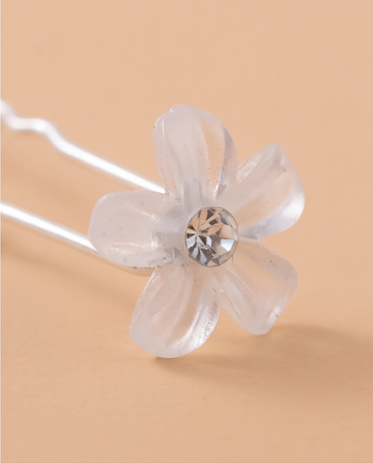 White flower hair pins worn along a braid