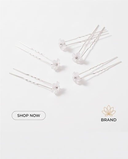 White flower hair pins worn in a half-up hairstyle