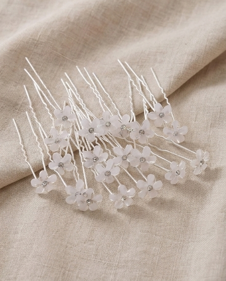White floral hair pins in a clear container
