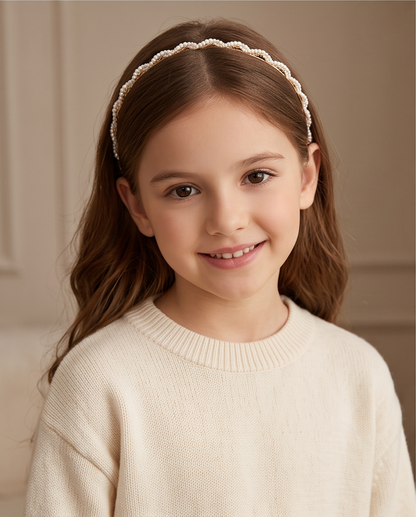 Petite Pearl headband with small white pearl-look beads worn with a bun.