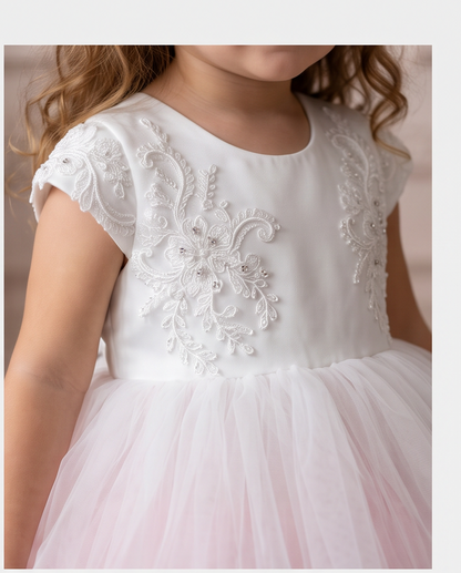 Back view of the Blush Blossom dress showing the white bow and pink and white tulle tiers.