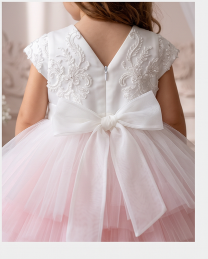 Side view of a girl turning in the Blush Blossom dress, showing the layered tulle skirt.