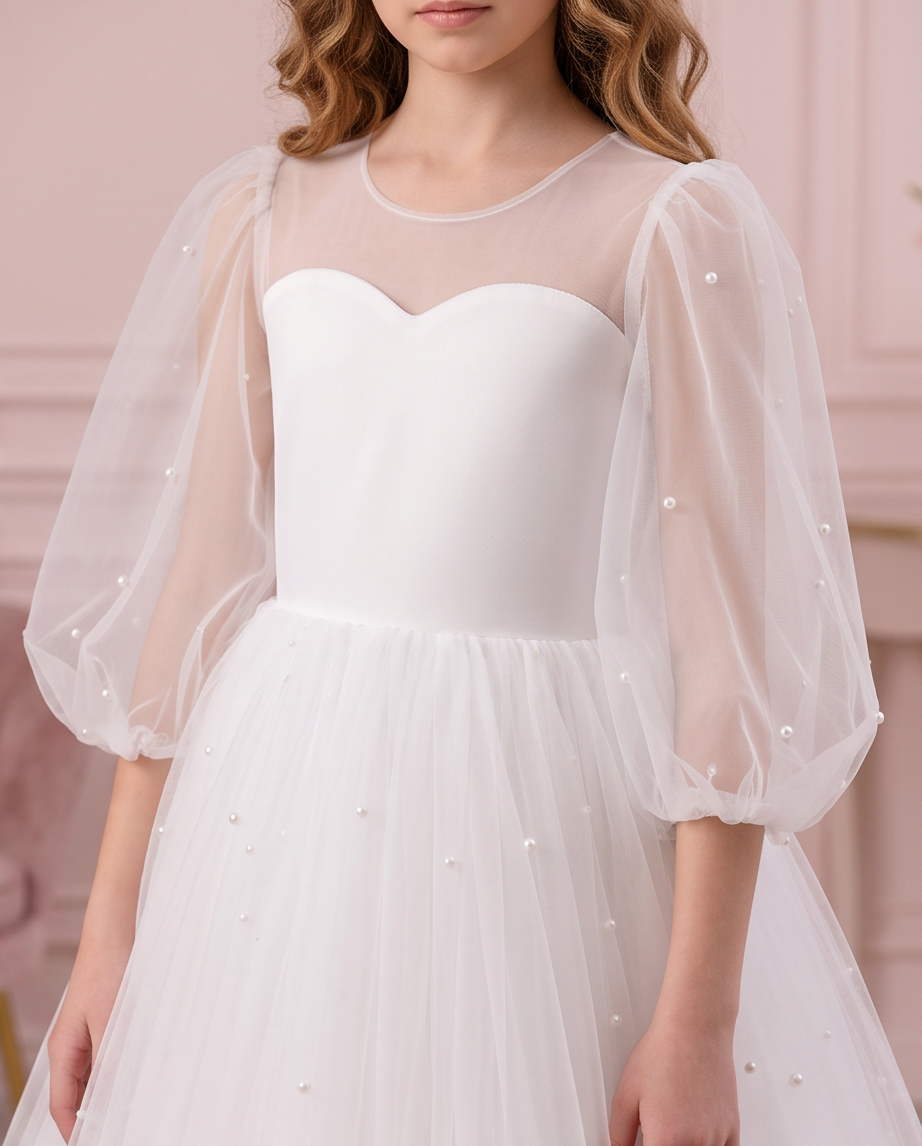 Front bodice detail of the Pearl Reverie dress with a sheer round neckline and pearl-detailed three-quarter puff sleeves.