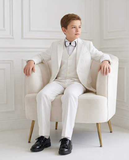 Angled close-up of boys’ white formal suit lapels and bow tie