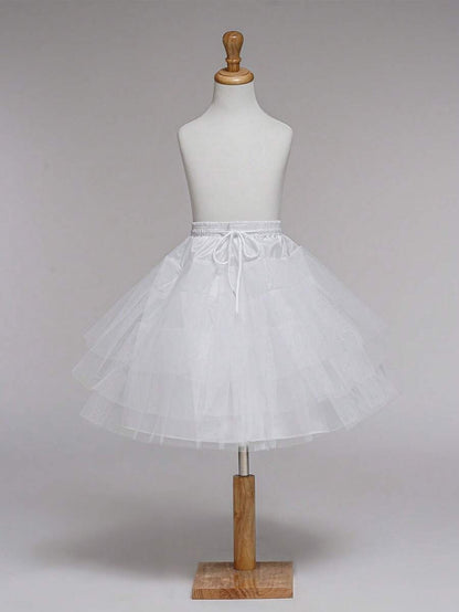 White petticoat on a mannequin against a plain background