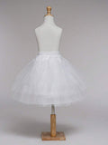 White tulle skirt on a mannequin against a plain background