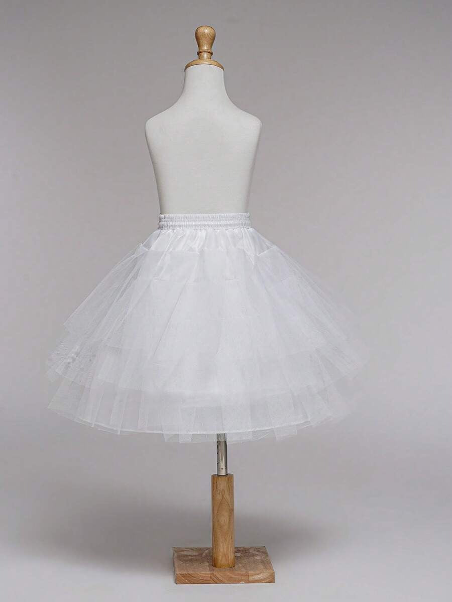White tulle skirt on a mannequin against a plain background
