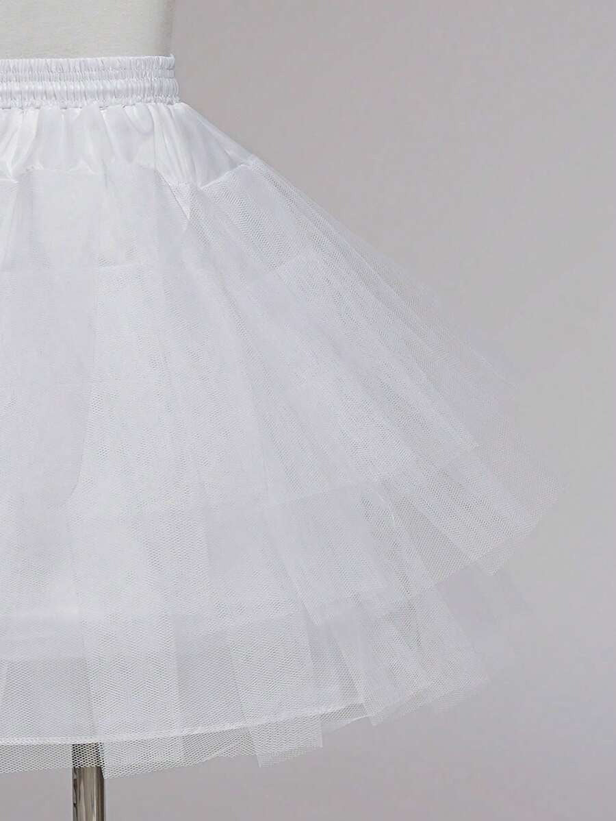 White petticoat on a mannequin against a plain background