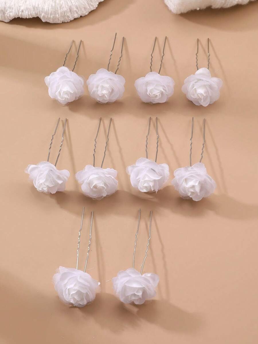 10 white chiffon rose hair pins arranged in rows on beige background, showing U-pin style