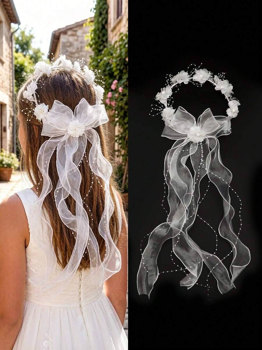 Girl wearing white floral crown communion veil with pearl ribbon and organza bow, back view outdoors